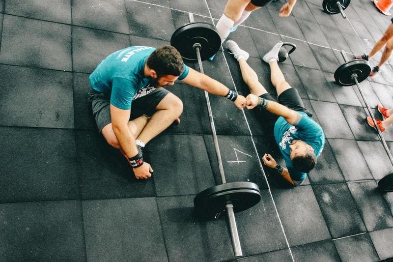 Personal Trainer Working out With a Client in a Gym