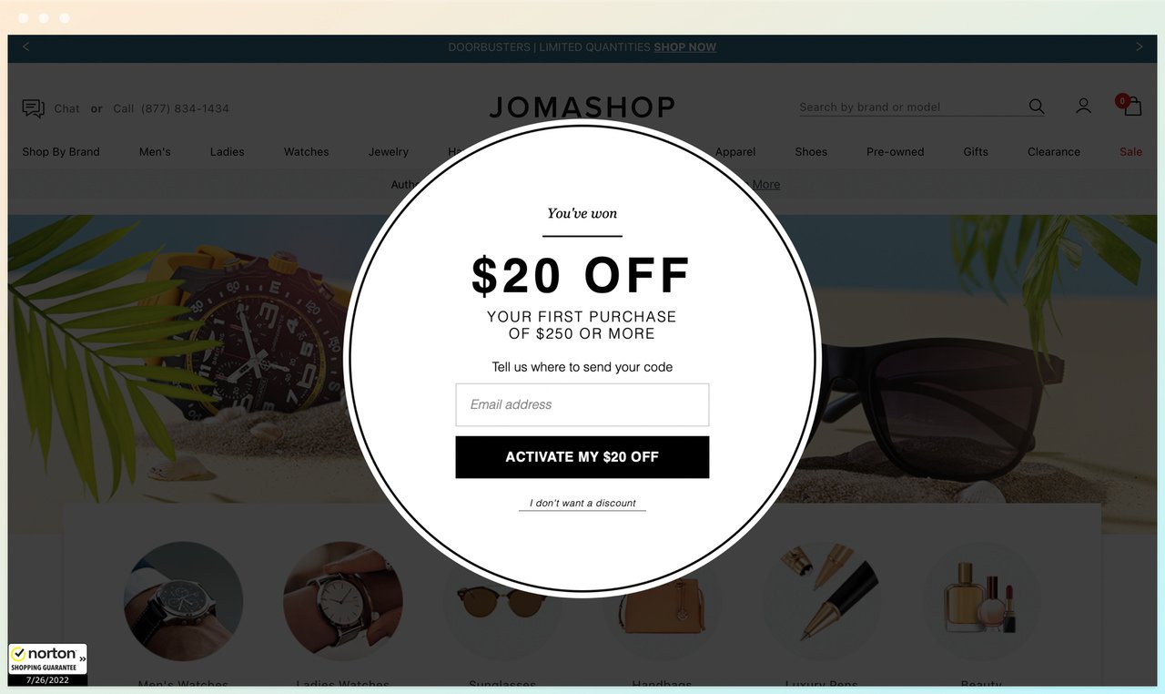 Jomashop discount offer popup offerin $20 off with an email box below, behind the website showing sunglasses on the right and a watch on the left