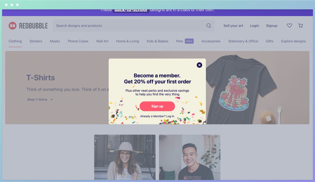 redbubble homepage showing a popup with a sign up button in return for 20% off and a tshirt photo on the background