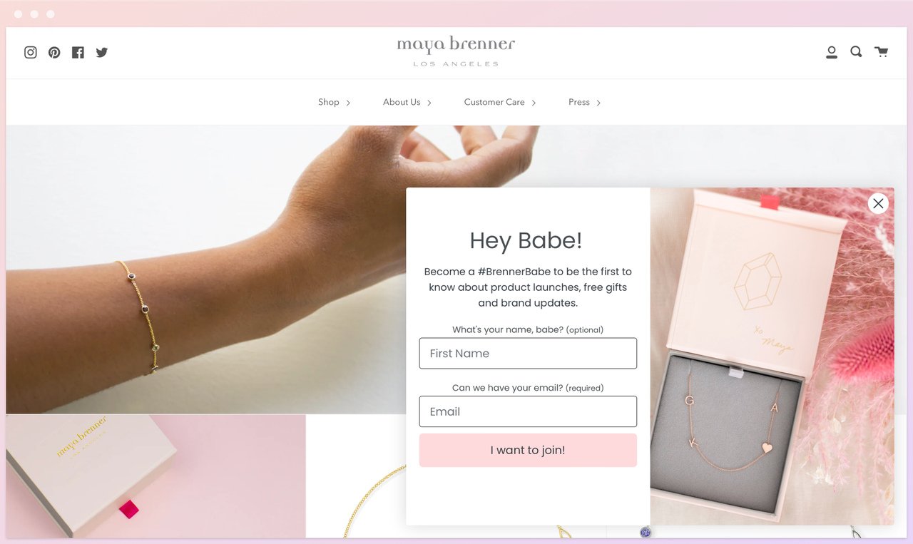 maya brenner's homepage showing a popup with the headline "hey babe!" and name and email boxes to be filled showing some jewelry behind