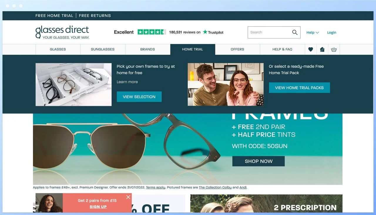 glasses direct homepage showing different panels and glasses with a blue background and a pink popup teaser on the left hand bottom