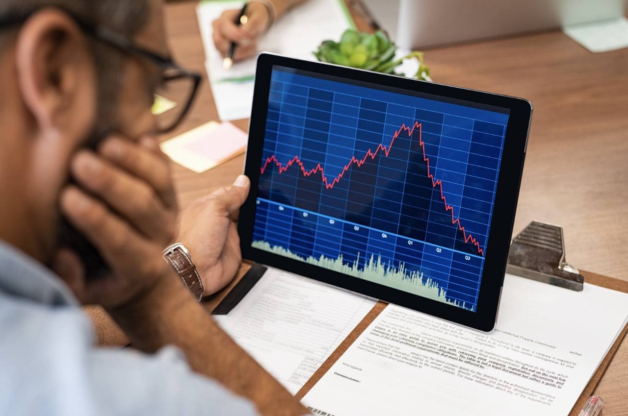 a man looking at laptop screen and watching the website c rash stats and data