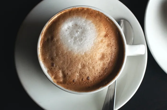 white ceramic coffee cup on saucer