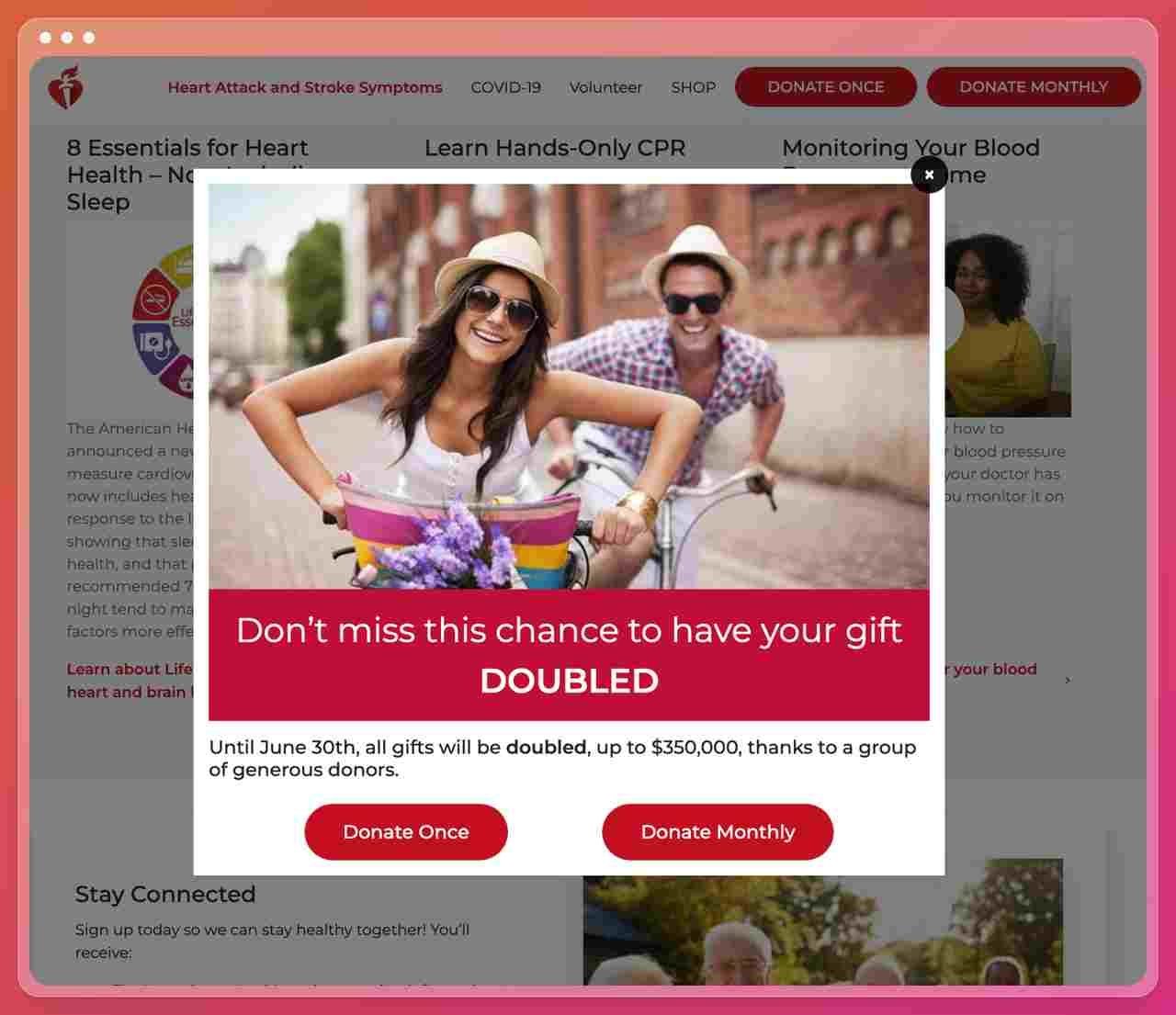 a screenshot of The American Heart Association nonprofit website showing a popup with a picture of a couple riding a bicycle smiling to the camera being happy with a text that asks the visitors to double their donation with two different call to actions that offer donate once or donate monthly 